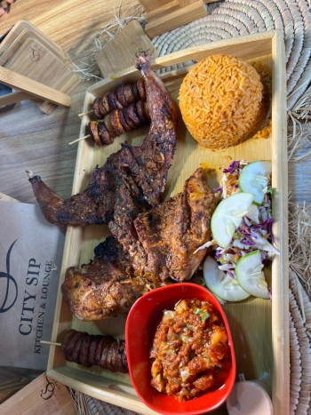 Guinea Fowl Platter; Roasted Peppered Guinea Fowl, Smoky Jollof, Fried Plantain Coslaw Salad (serve with) Vegetable Pepper Sauce