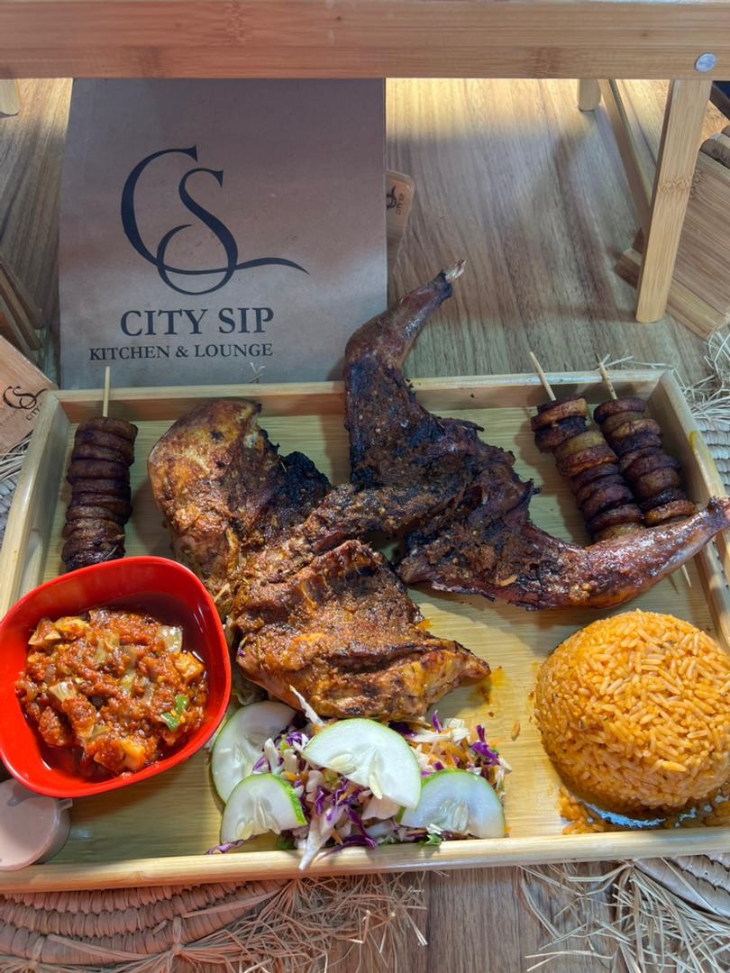 Guinea Fowl Platter; Roasted Peppered Guinea Fowl, Smoky Jollof, Fried Plantain Coslaw Salad (serve with) Vegetable Pepper Sauce